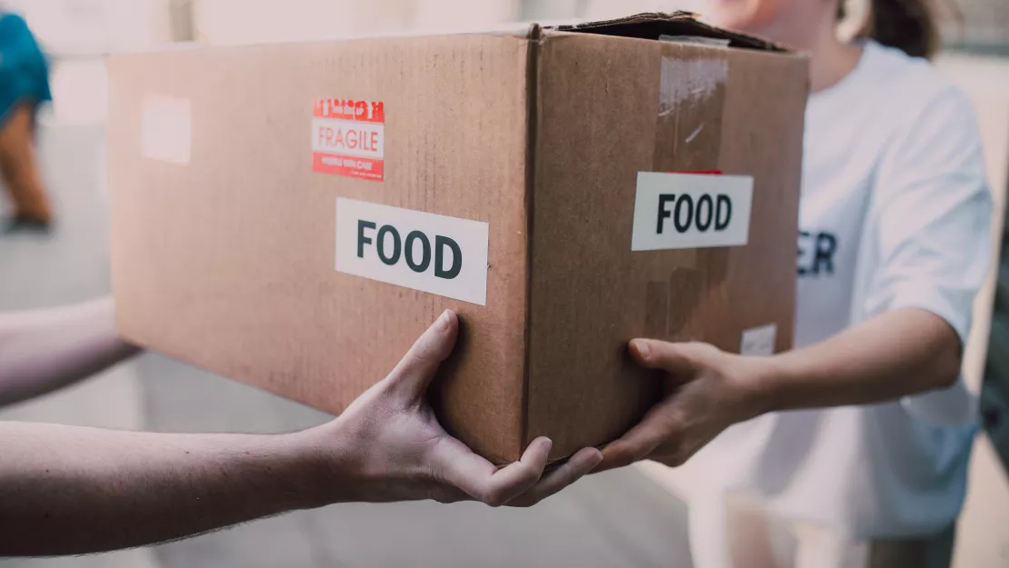 volunteers holding food box