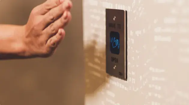 Hand waves in front of sensor to open door.