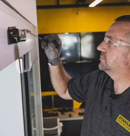 A person installing a set of doors.