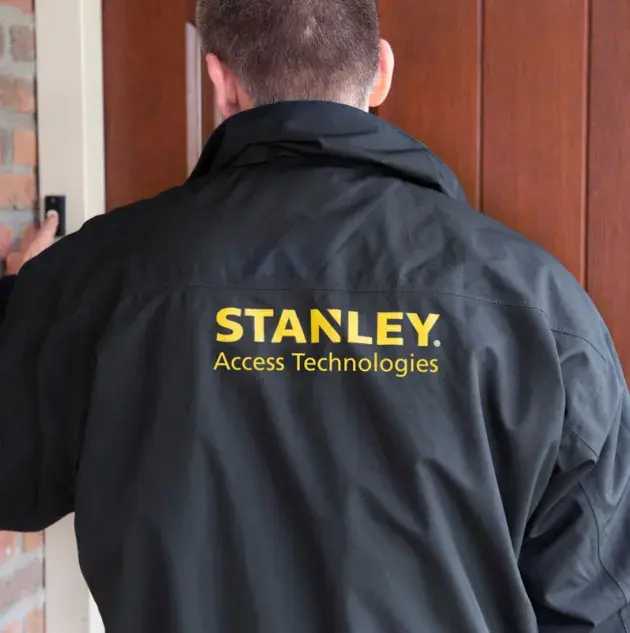 A person wearing a Stanley access technologies jacket.