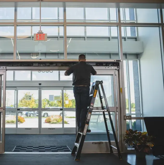 A person installing a set of doors.