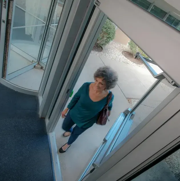 A person walking through a set of doors.