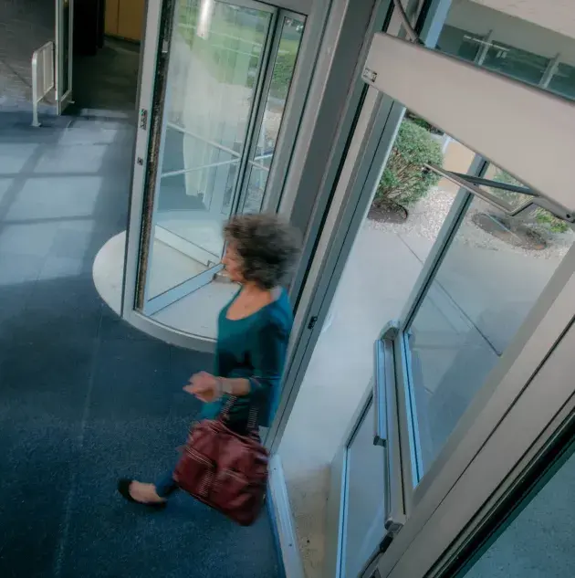 A person walking through a set of doors.