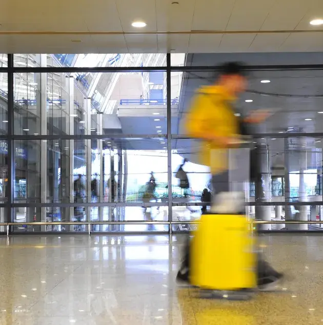 A person walking through a transit station.