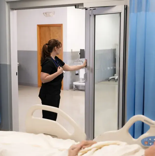 Nurse opening ICU door