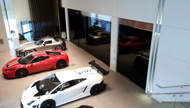 A set of all glass doors at a car dealership.