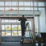 A person installing a set of doors.